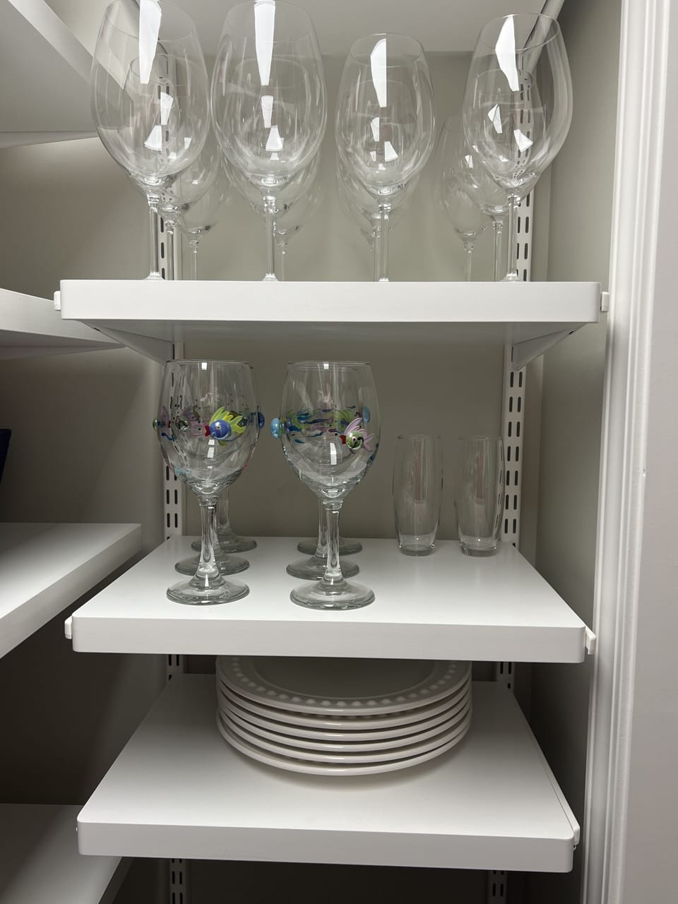 Wine glasses and extra plates in pantry