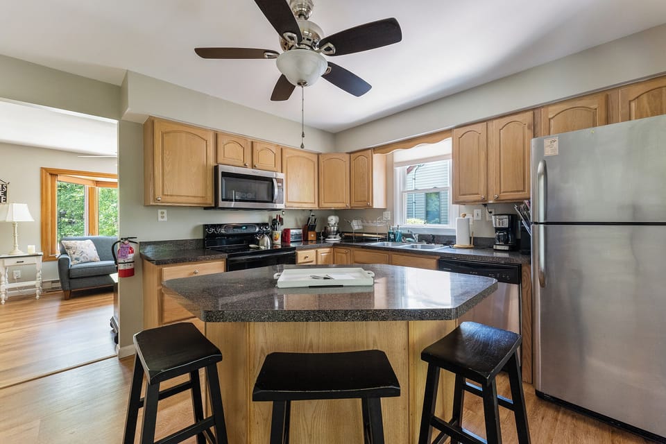 Seating for three on the island; ceiling fan