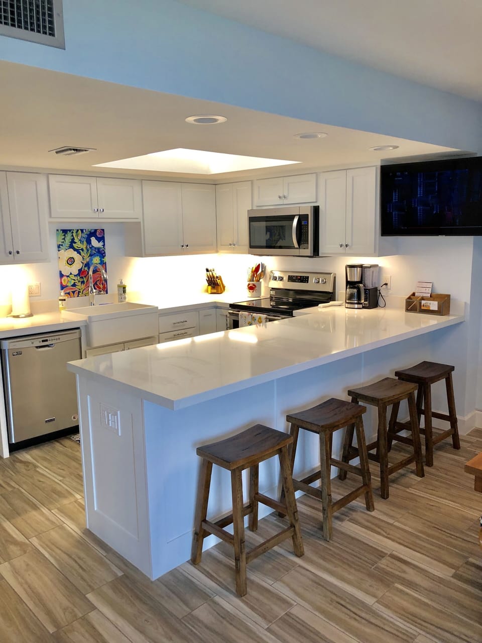 Kitchen island w/ quartz counter. TV can rotate to view in kitchen and living.