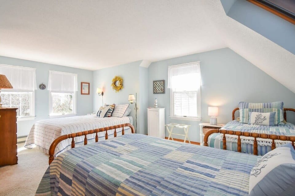bedroom with full bed and two twin beds