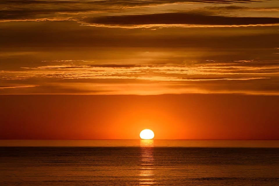 Unobstructed sunsets views over Lake Michigan from 2 balconies w/glass railings