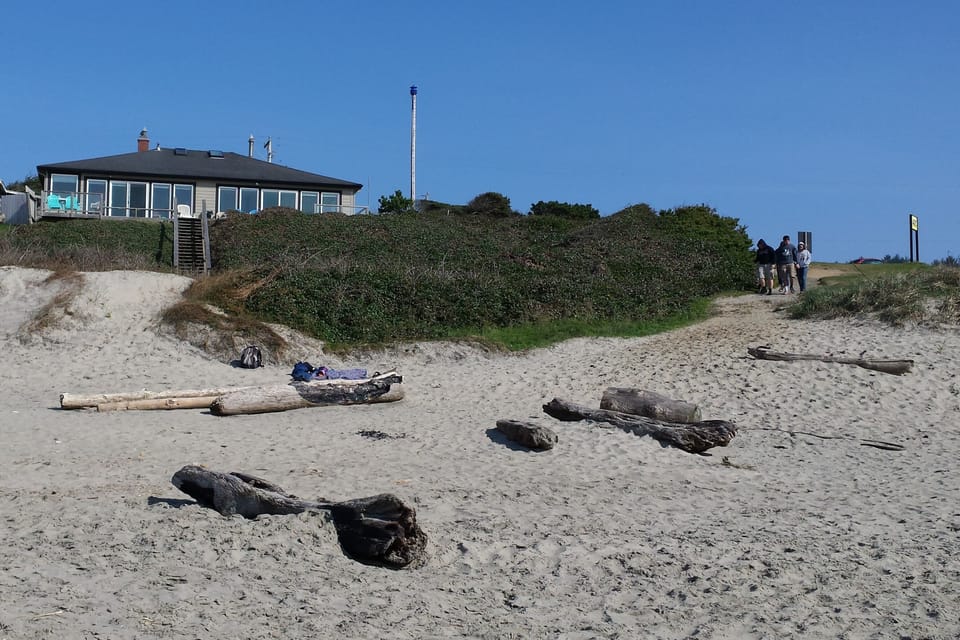 Path from adjacent park. Beach house in background.