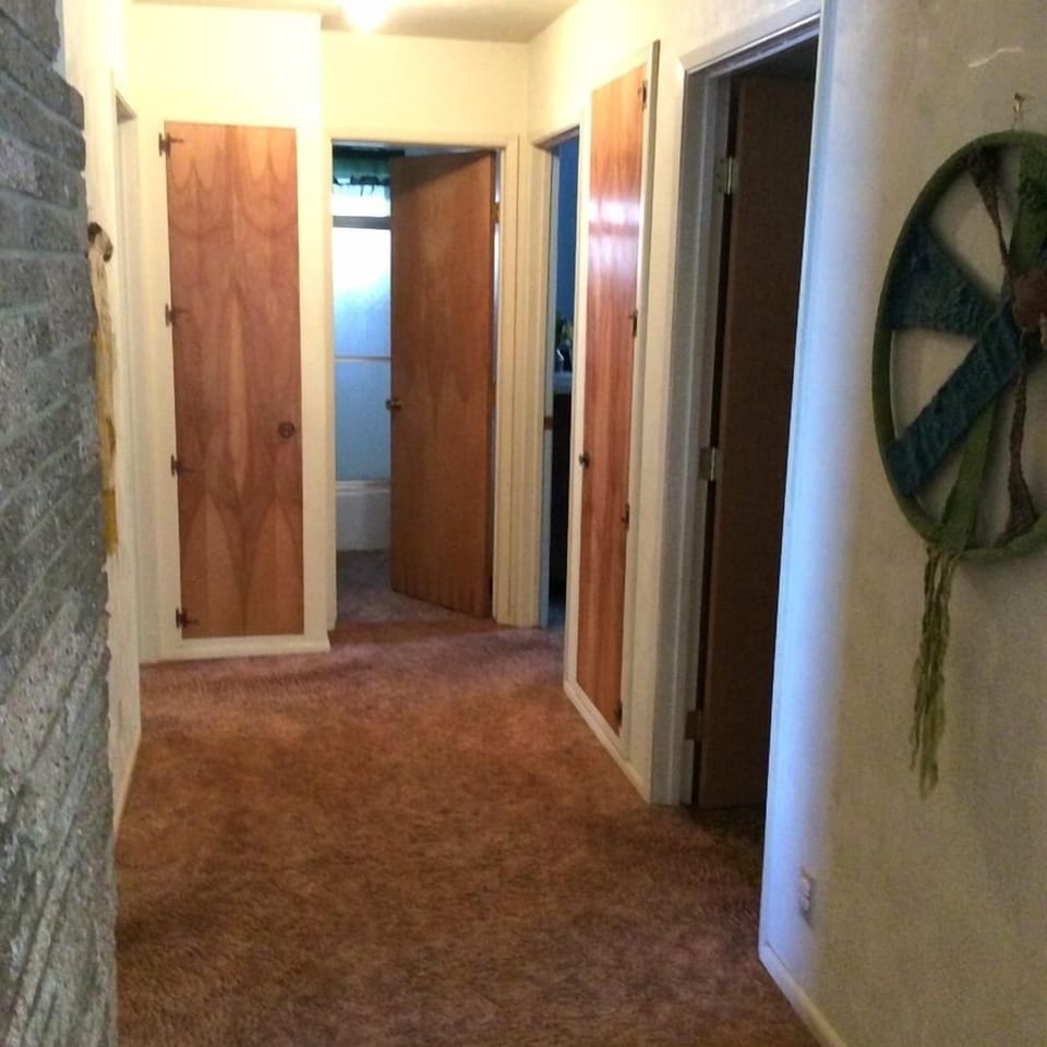Hall, with entrances to 3 bedrooms and bath