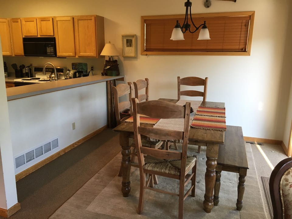 Dining area, kitchen to left, deck to right out sliding glass door