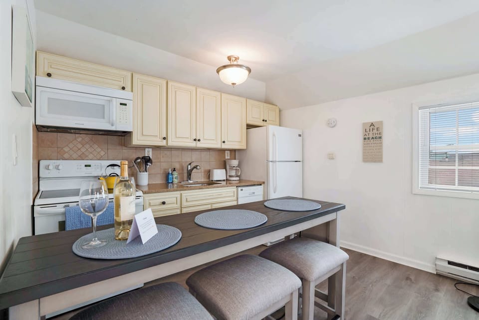 Kitchen with breakfast bar, microwave, and full-size refrigerator
