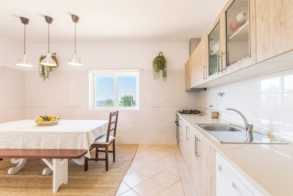 Bright open-plan kitchen and dining area with pendant lights — Villa Rita, holiday villa in Silves