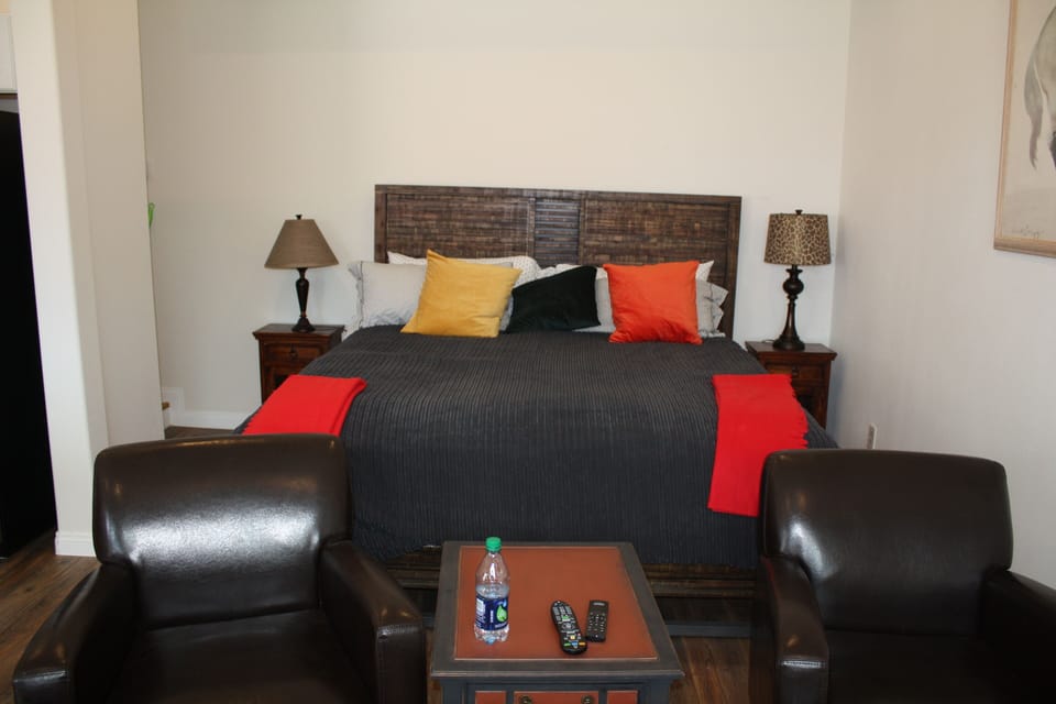 king bed with sitting area in front.