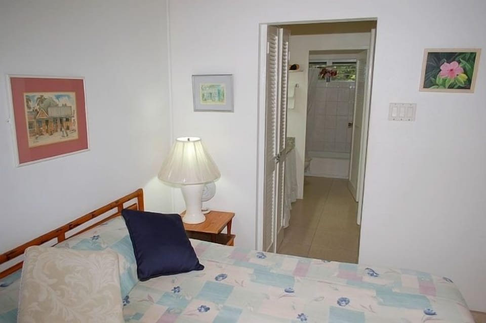 bedroom with view to bathroom, & dressing area which has full length mirror