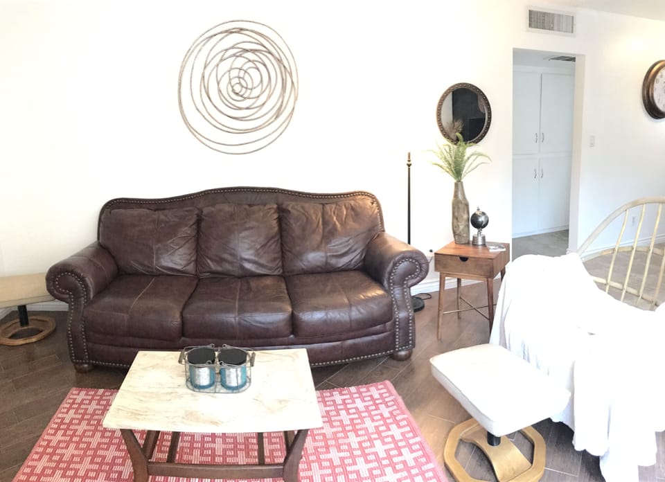 Living Room, with a Modern Bohemian Decor. Wood and Leather Furnishings. 