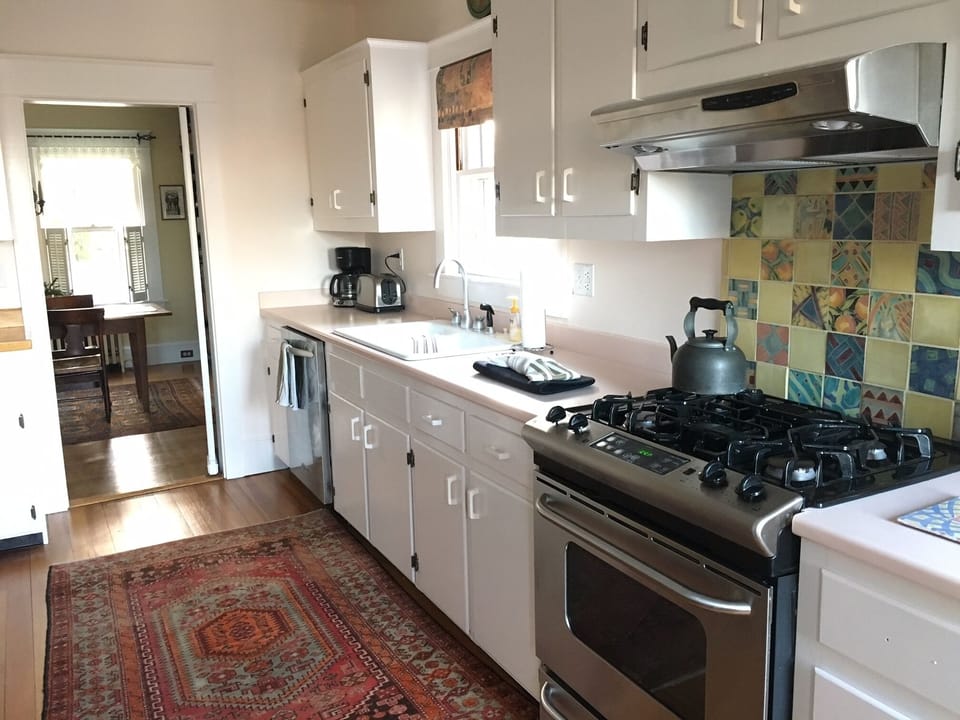 Kitchen with large gas stove, dishwasher and large refrigerator. 