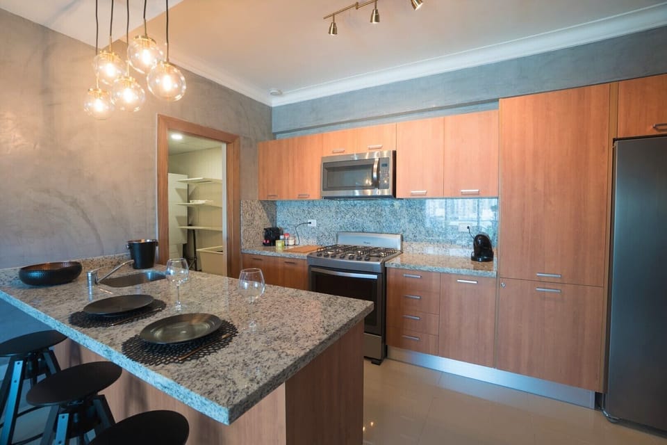The Spacious living room comes with an open kitchen and a private balcony + view
