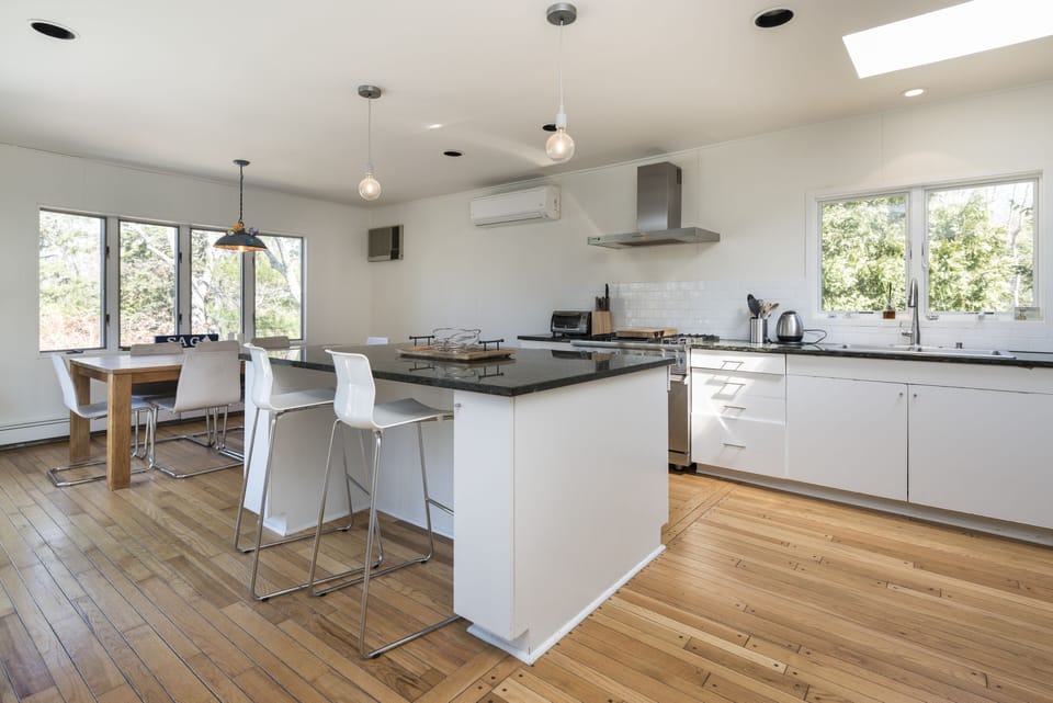 Wolff stove, marble island, 8 person dining table. 