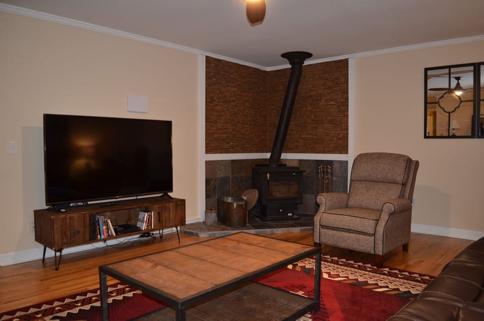 Large screen 4K smart TV and wood stove in Great room.