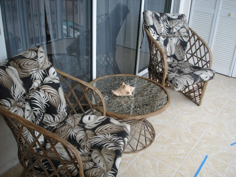 Lanai table and chairs in front of Master Bedroom