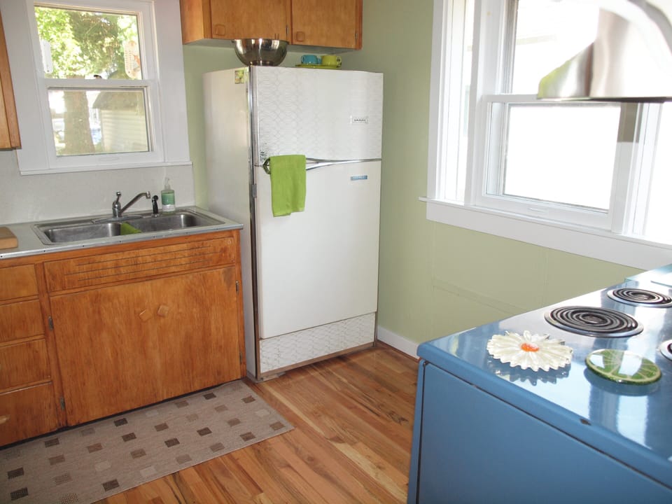 Fun Kitchen with cadet blue electric Stove. Extra college size refrig. for soda.
