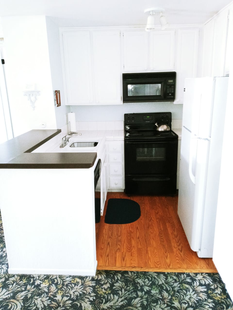 Tidy kitchen with easy care white tile countertops.

