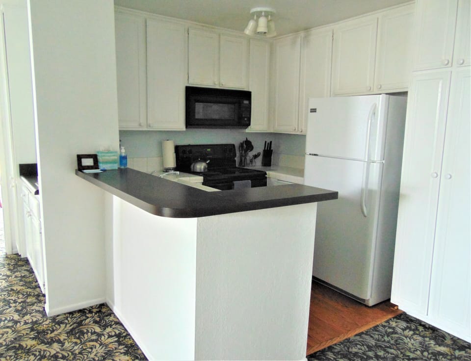 Kitchen. Hall to left. Straight to second bedroom;left in hall to first bedroom 