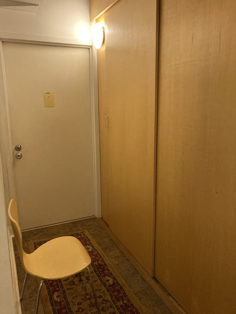 Laundry behind sliding door on right