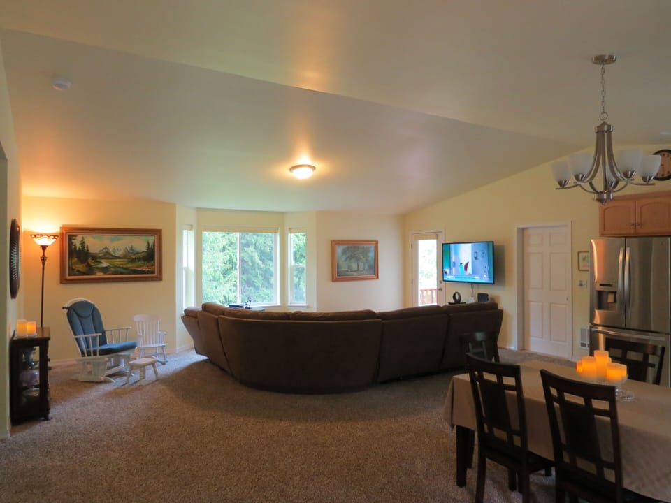 Look out at the trees from the roomy yet cozy Greatroom with vaulted ceiling