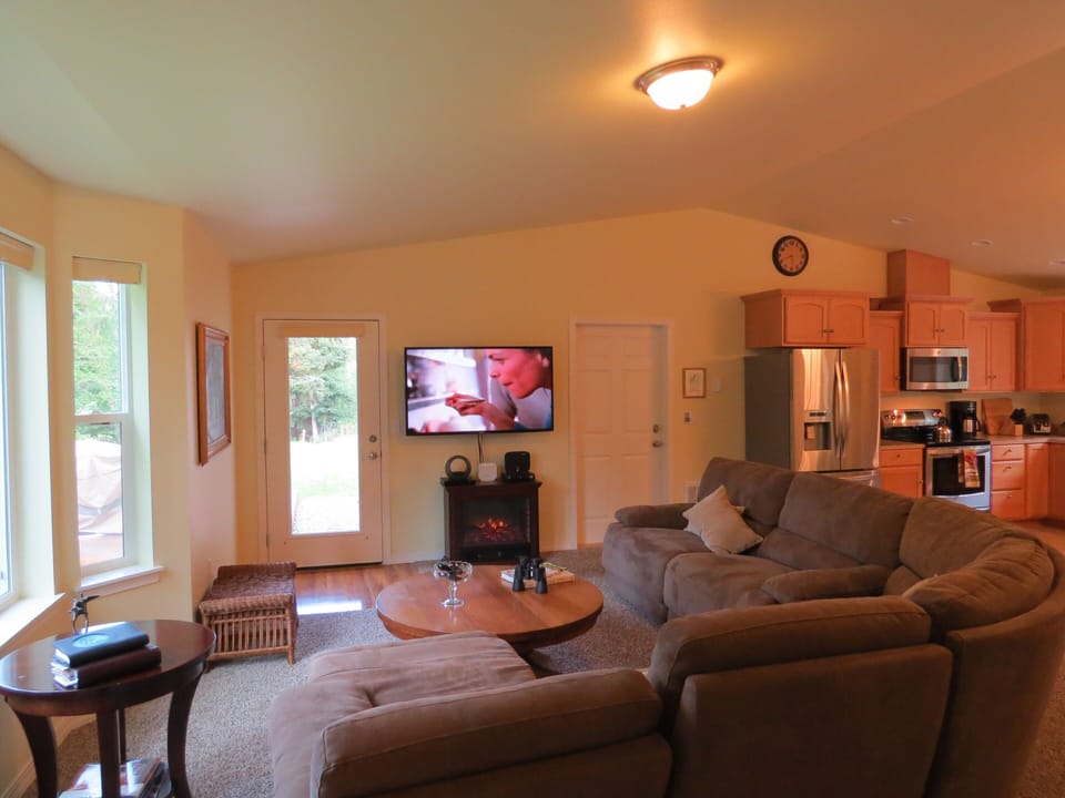 Greatroom has electric fireplace and big-screen TV with Blu Ray player