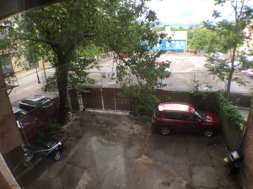 There is an off street, secure fenced parking spot for you (where red car is)