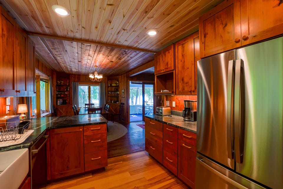 View from kitchen to dining room, screened in porch and beach.  
