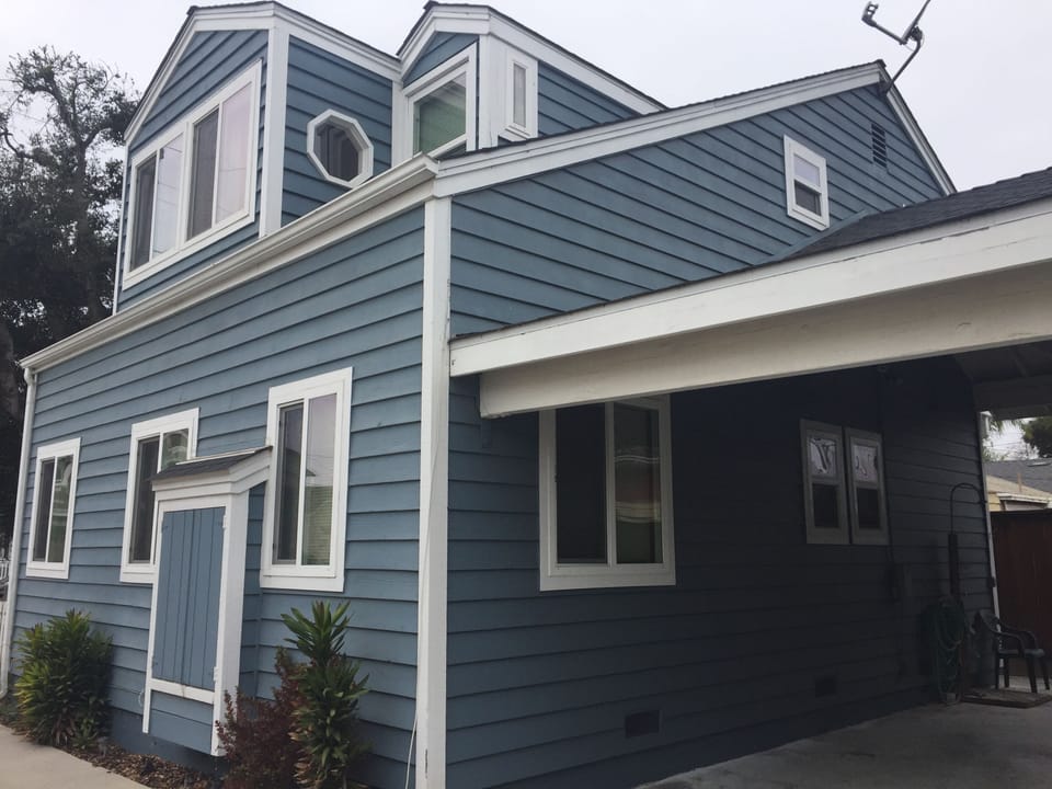 Side view of stand alone townhome with carport for parking.