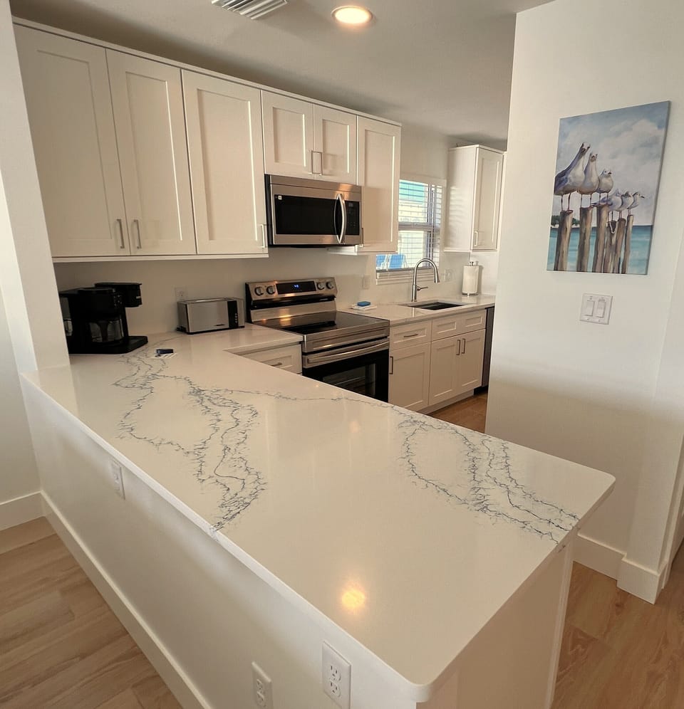Custom fully stocked kitchen with a view of the community pool from the Sink!