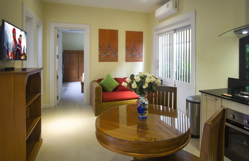 Air-conditioned living area has SMART TV with Netflix & Youtube & dining table 