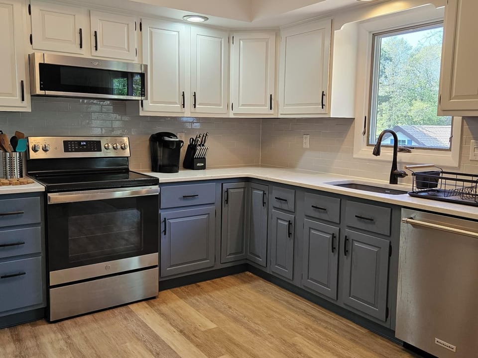 Newly painted cabinets, new counter top, sink, faucet and backsplash.