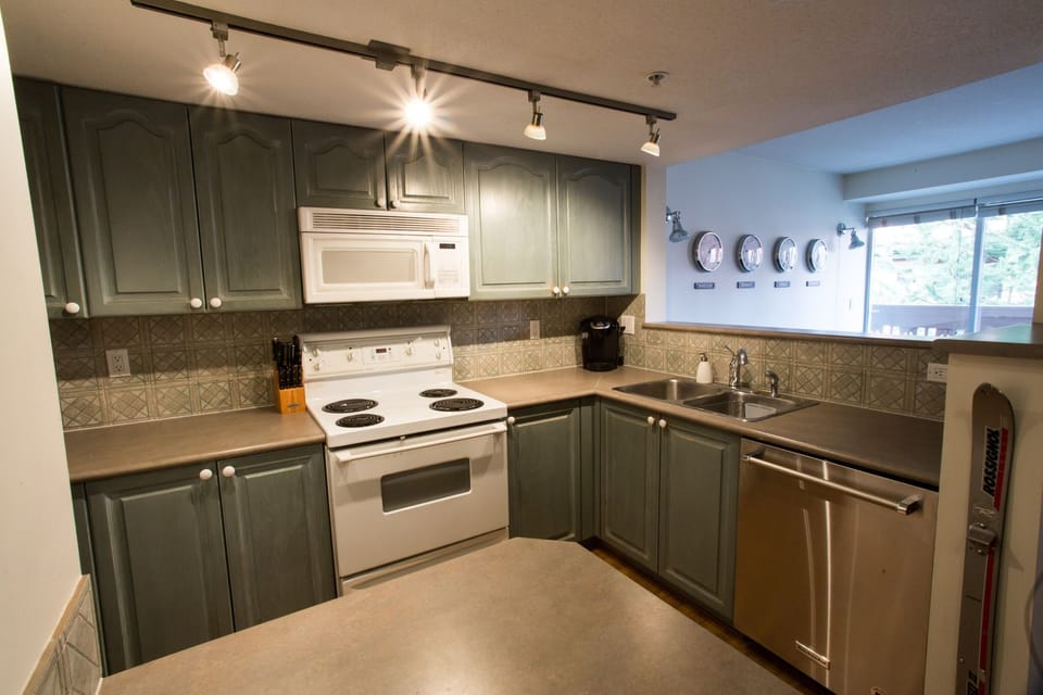 See previous photo. New Range, microwave and cookware.