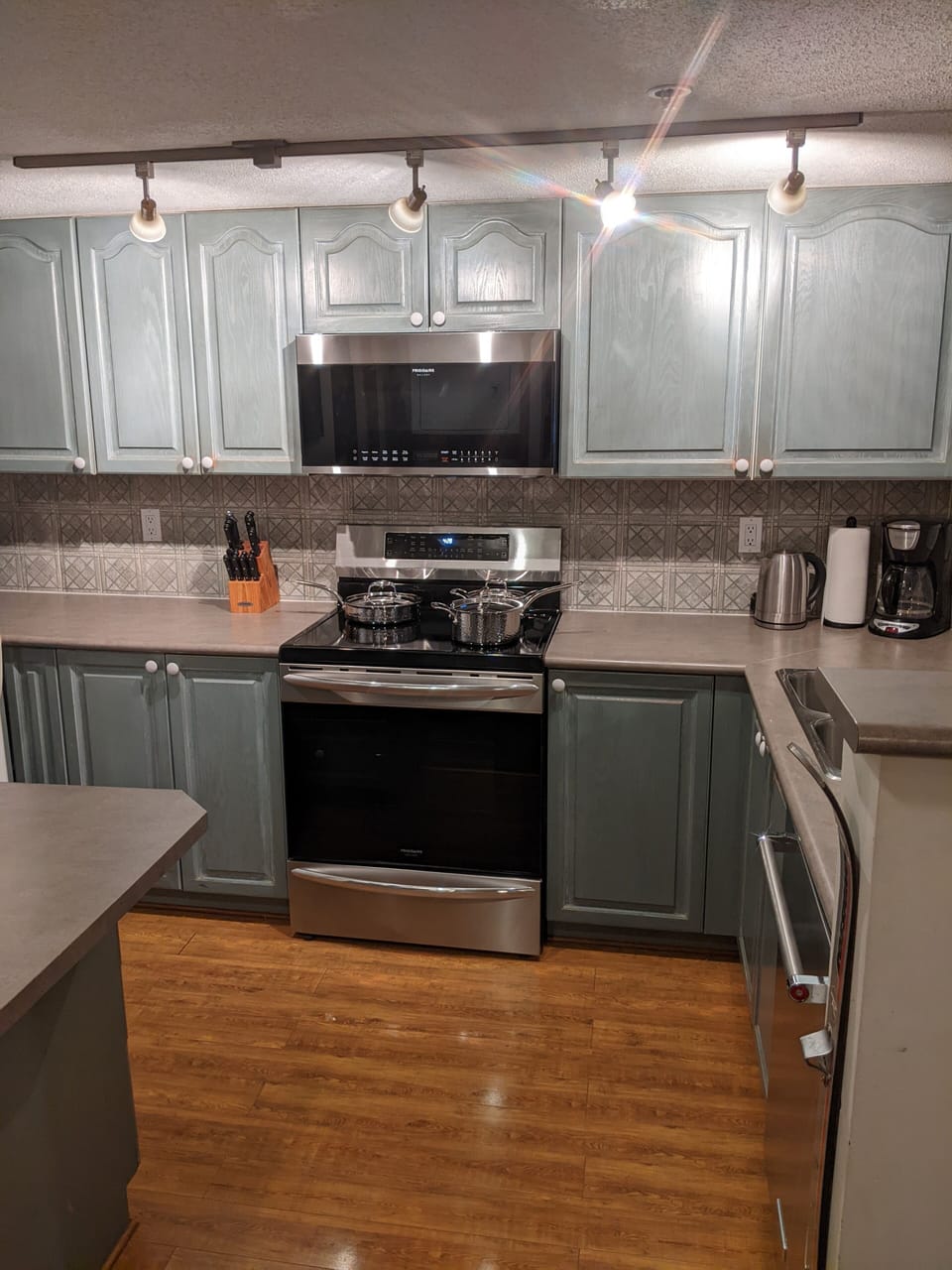 Fully loaded kitchen with all appliances, big & small, ready for a gourmet meal.