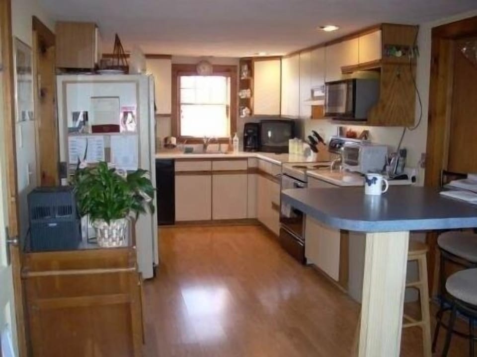 Kitchen with an island that is great for breakfast and coffee. 