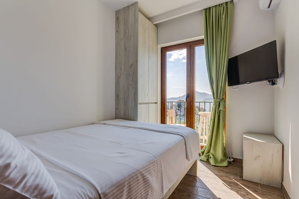 Small room with flat screen TV and balcony