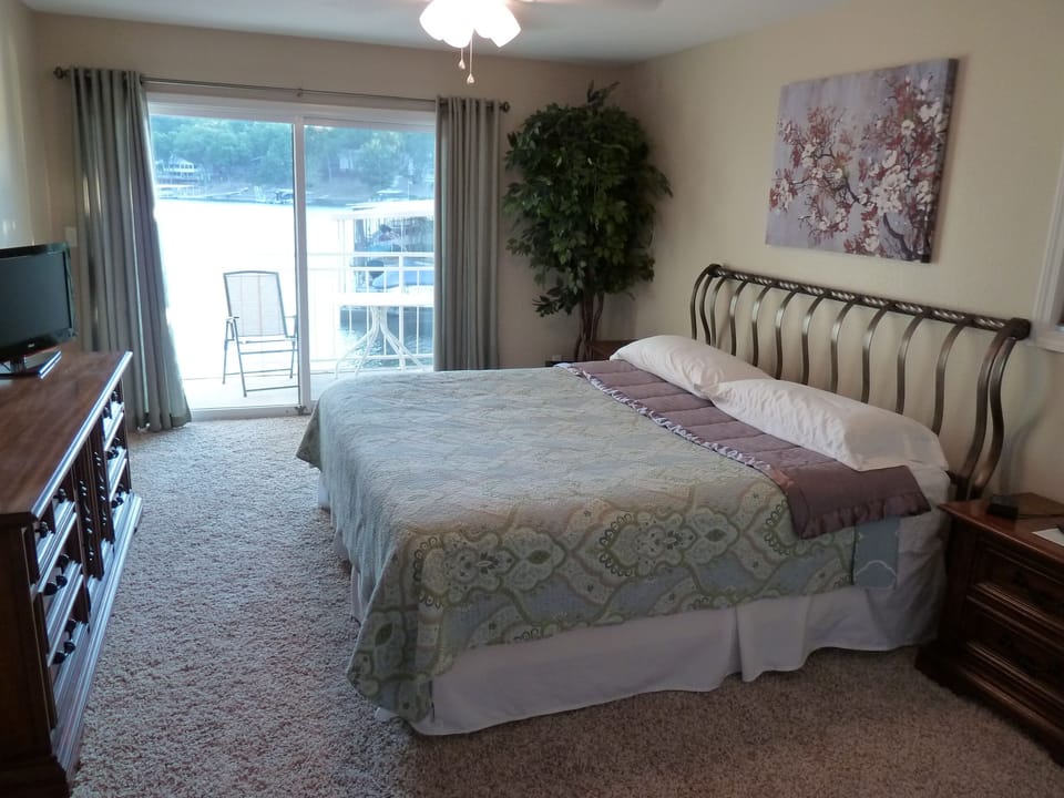 Large master bedroom, King Bed, ceiling fan, and private deck.