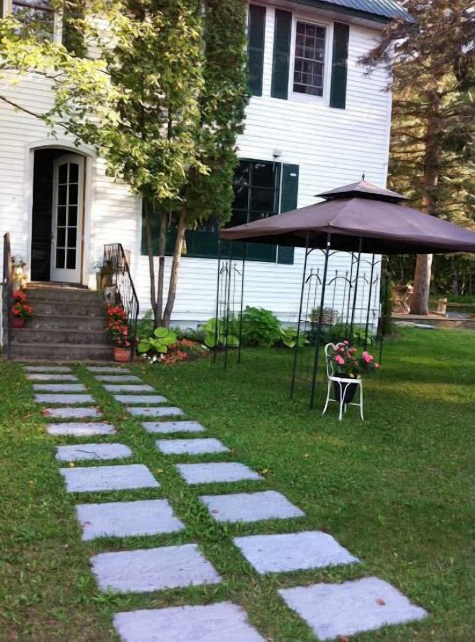 Backyard path to Great Room  from terrace overlooking lake . 
