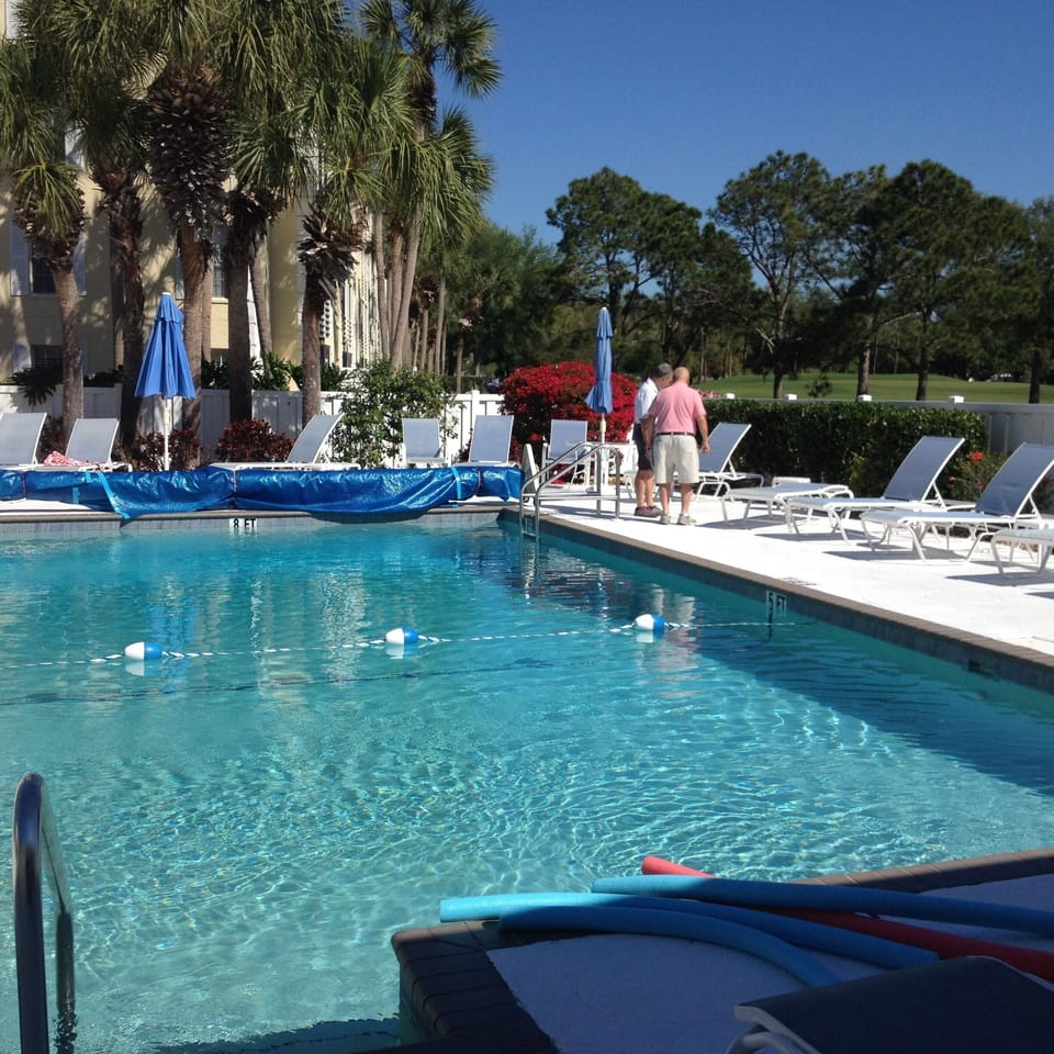 Pool looking to fairway behind condo
