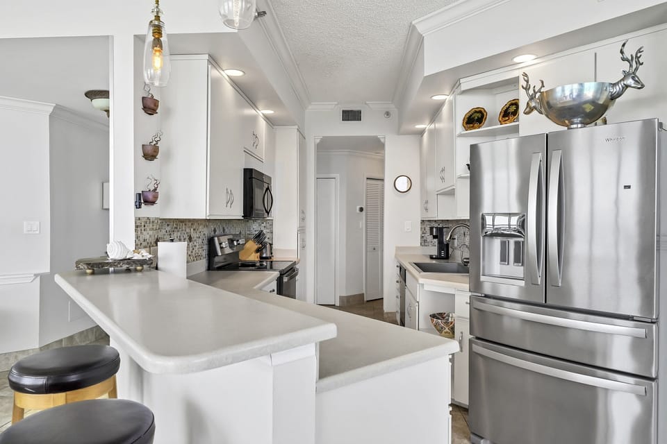 Kitchen has both a large pantry and plenty of cabinets for storage.