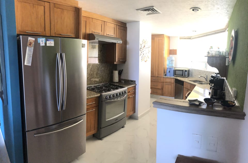 Fully equipped kitchen with stainless appliance and granite counters