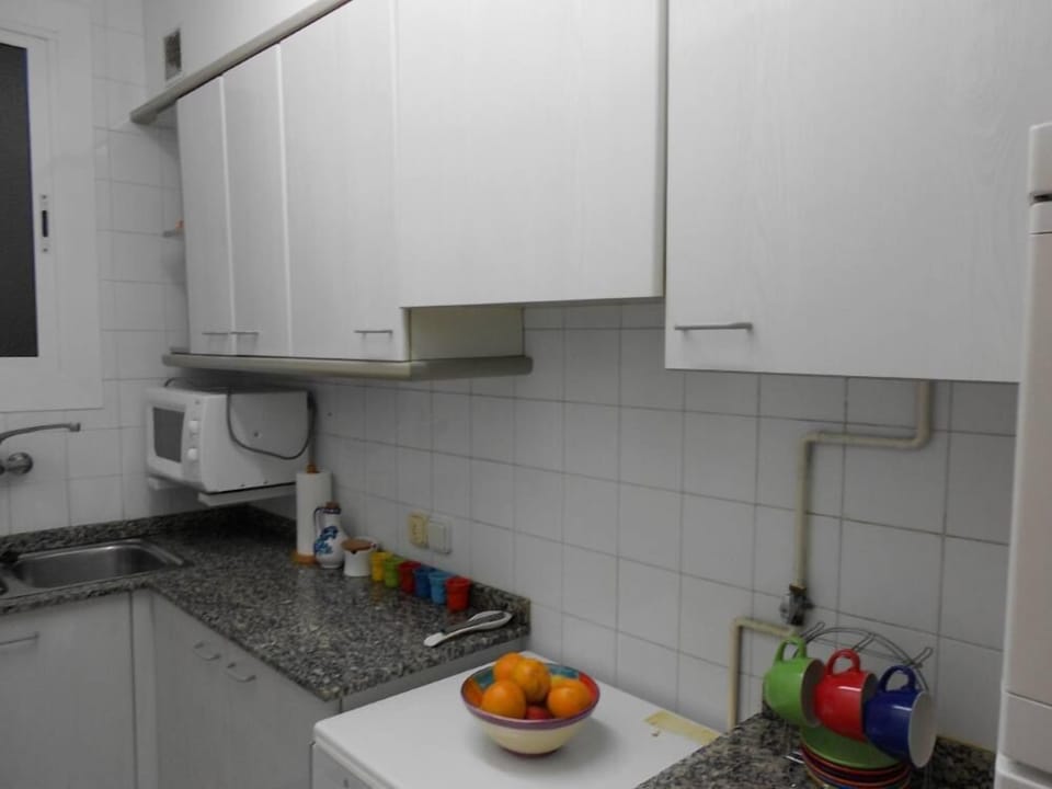 Kitchen equipped with microwave, refrigerator and oven.