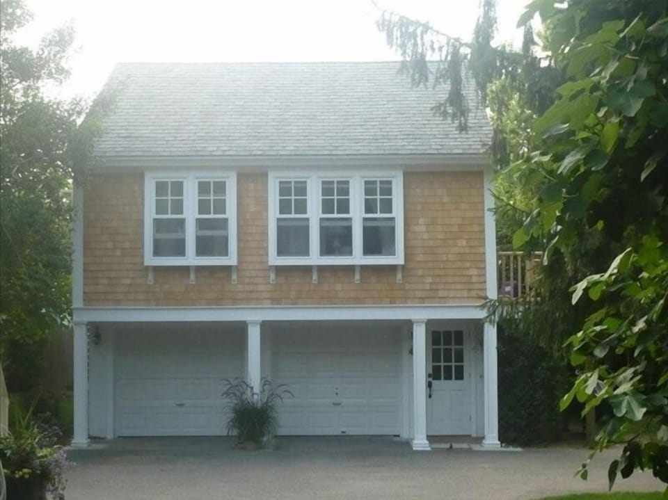 The carriage house apartment is up a stairway. Garage is offset from house