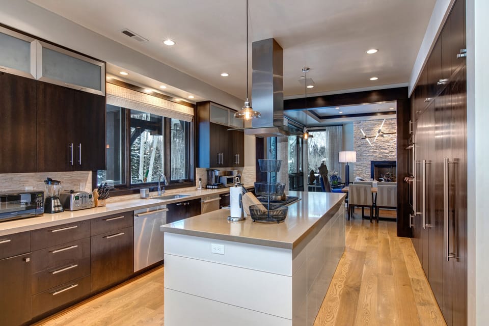 Fully Equipped Gourmet Kitchen with High-end Appliances including a 6-Burner Stove, 2 Dishwashers, Double Ovens, and Oversized Refrigerator