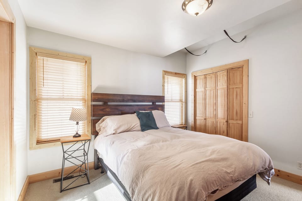 The second bedroom has beautiful views from the windows. The comfortable queen bed is the perfect place to rest after an adventurous day.