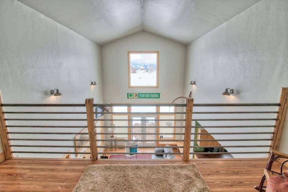 A view from the loft overlooking the living area and views.