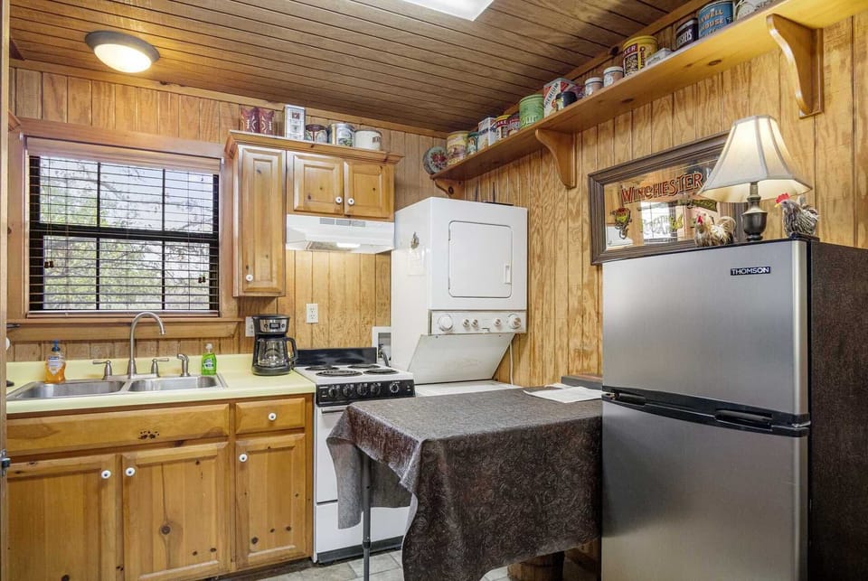 The fully-appointed kitchen is loaded with appliances, including a convenient stackable washer and dryer in the corner.