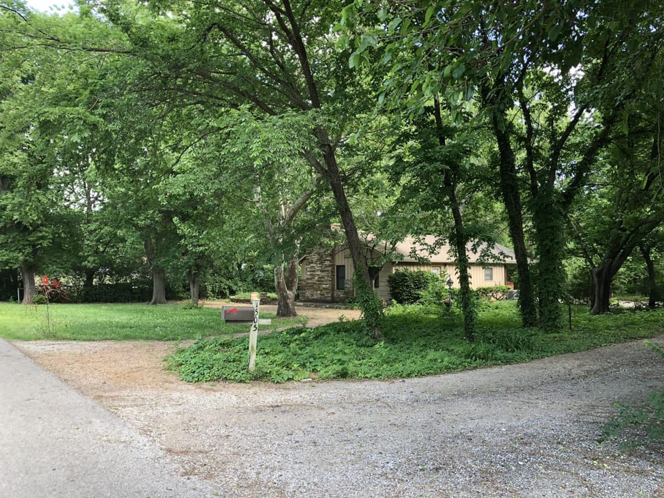 Property surrounded by a field and quiet neighbors with horses on an end street.