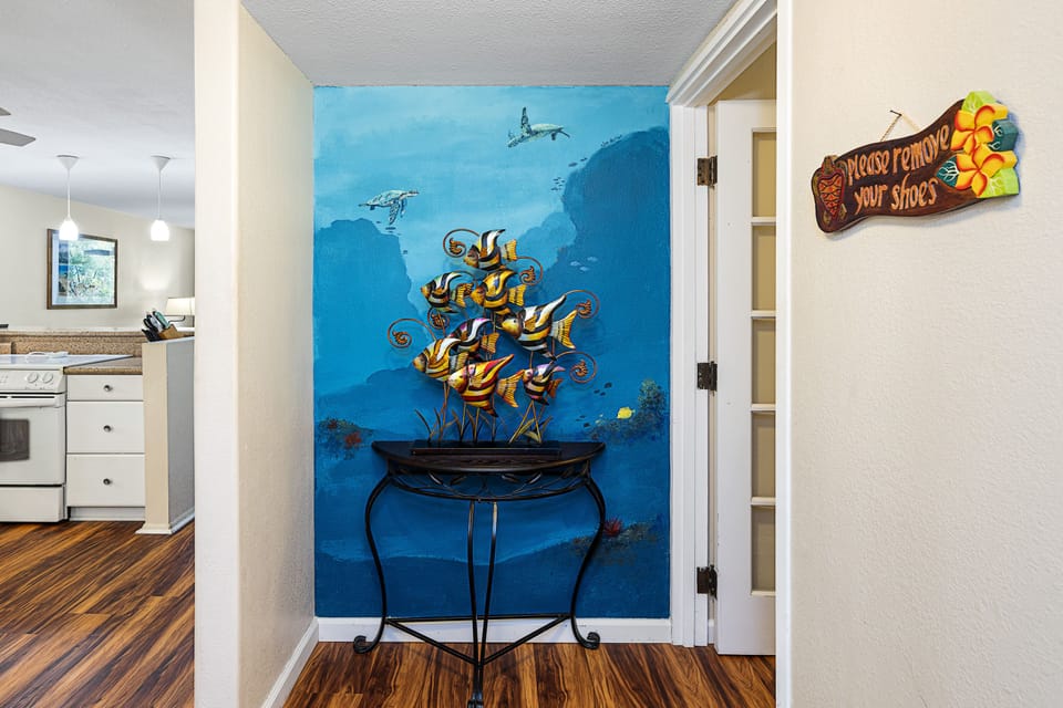 Cool Metal Fish Sculpture Showing the Kitchen Entry on the Left and the Primary Bedroom Entry on the Right