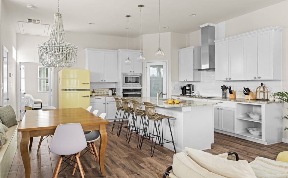Kitchen & Dining — White Cabinets, Granite Island, Yellow Retro Fridge, Rattan Stools & Beaded Chandelier