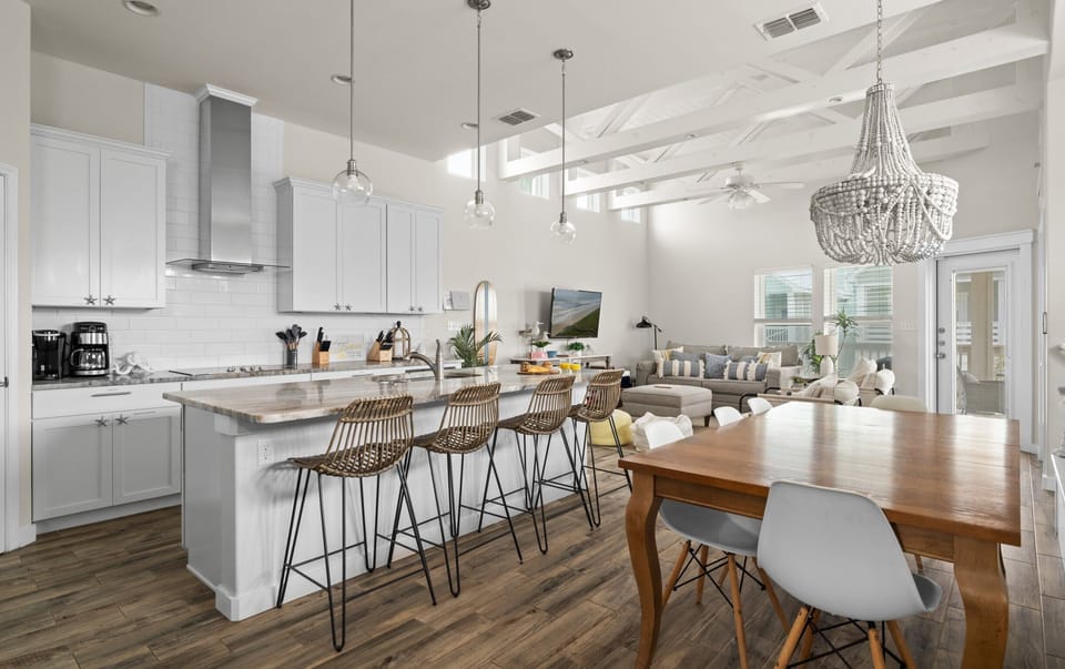 Kitchen & Dining — White Island, Rattan Stools, Globe Pendants, Beaded Chandelier & Exposed Beams
