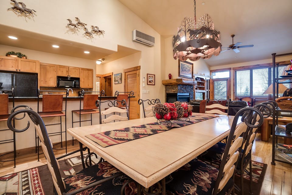 Gather around this spacious dining table where memorable meals await, seamlessly connected to your fully equipped kitchen and cozy living area.